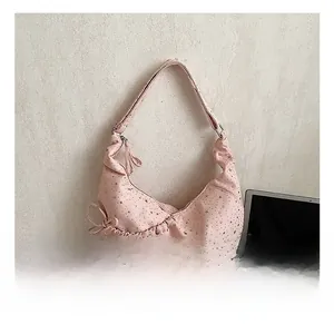 Detail show of pink star pattern pleated crescent bag with delicate bow knot side strap