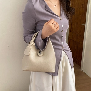 Elegant cream white lychee pattern bucket bag with silver twist lock and top handle