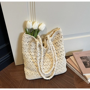 Close-up of cream crochet tote bag featuring wave-pattern hollow knit and boho texture
