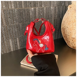 Detail shot of mini red quilted leather bag featuring a colorful horse embroidery design