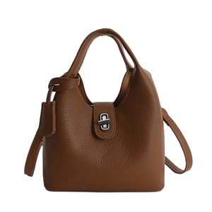 Classic brown pebble leather bucket bag with top handles and adjustable shoulder strap