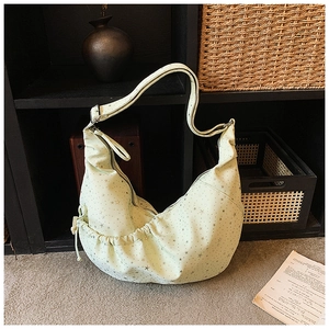 Detail of printed crescent shoulder bag with silver stars and adjustable wide strap
