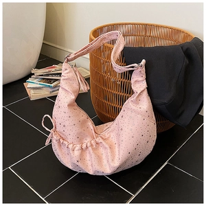 Detail of pink hobo bag featuring silver star patterns and drawstring pleated texture