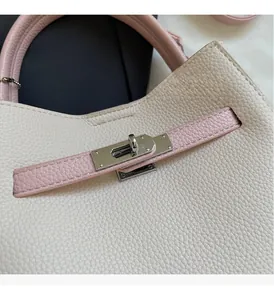 Detail of lychee pattern leather handbag with silver mirror swivel lock closure