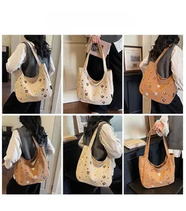 Detail view of large canvas tote bag with animal prints in beige and brown styles