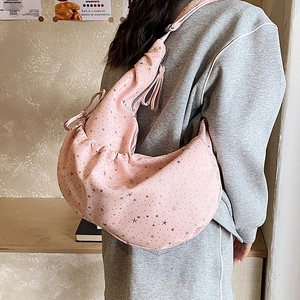 Detail of light pink crescent bag with silver star prints and pleated texture design