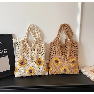 Detailed close-up of woven tote bags featuring yellow sunflower crochet and decorative tassels