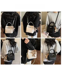Detail view of the versatile bucket bag in beige and black with a cute rabbit charm