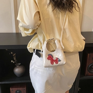 Detailed back view of a mini white quilted crossbody bag with cartoon horse embroidery