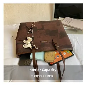 Macro view of the tote bag interior showing large capacity for tablet and phone