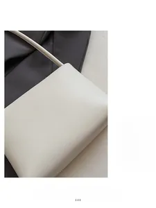 Close-up of soft beige faux leather crossbody bag with smooth matte finish texture