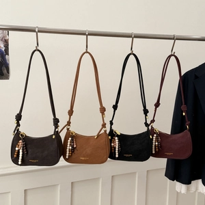 Detailed row of vintage style shoulder bags in dark coffee, brown, black and burgundy colors