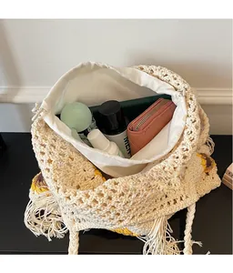 Detail view of woven crochet bag with yellow sunflower and drawstring canvas inner pouch