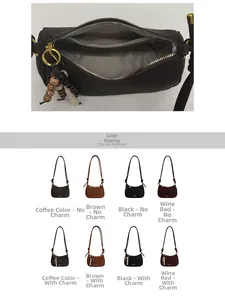 Detail view of a vintage dark brown barrel crossbody bag with a wooden bead charm