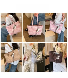 Detail view of large tote bags in pink, khaki, and blue with horse charm accents