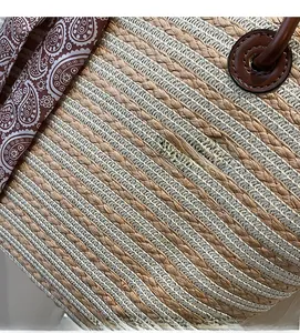 Detail of the dual-tone straw weaving pattern with a decorative paisley silk scarf
