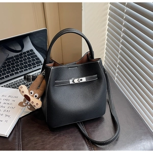 Detail of black pebbled leather bucket bag with silver clasp and contrast stitching