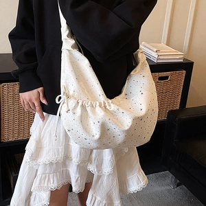 Detail of white star print dumpling bag showing capacity and soft pleated fabric texture