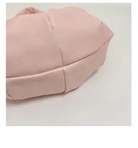 Detailed view showing the wide bottom construction and reinforced seams of the pink bag