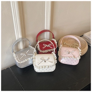 Detail of colorful mini lace bags with bows and heart pendants in silver red and pink