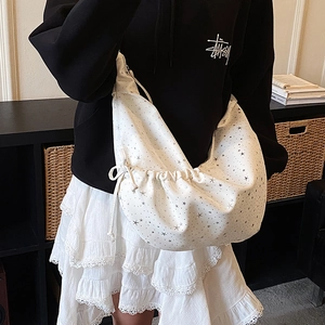 White crescent shoulder bag with silver star prints and pleated drawstring design
