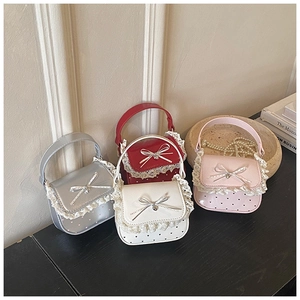 Detail of mini lace handbags in silver, red, white, and pink with heart patterns