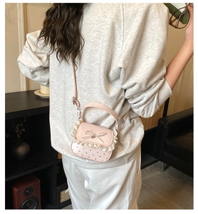 Pink sweet lace mini bag with heart cutouts shown in use on a crossbody shoulder