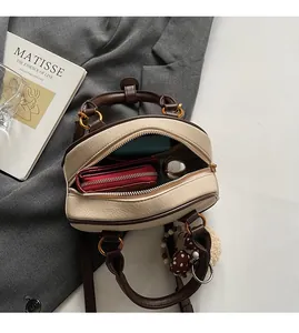 Internal view of the cream and brown pillow bag showing spacious storage for essentials