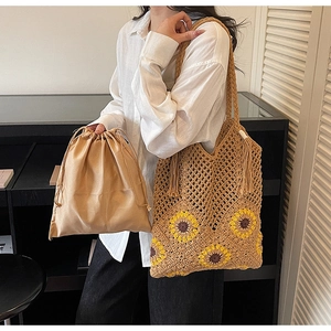 Detail of sunflower crochet tote bag with satin drawstring inner pouch and tassel