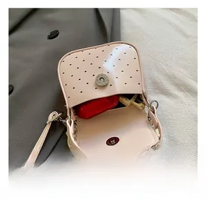 Interior view of pink mini crossbody bag with heart detail and white lace trim