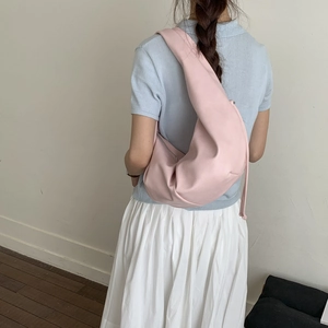 Detail of pink half-moon shoulder bag made of matte PU leather on a fashion model
