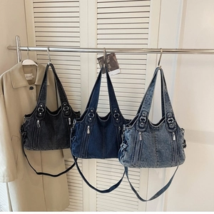 Vintage denim tote bags with zipper pockets and adjustable straps in three classic colors