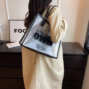 Detail shot of large capacity semi-transparent frosted PVC tote bag with black leather handles