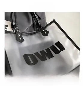 Close-up of semi-transparent frosted tote bag showing silver rivets and OWU lettering