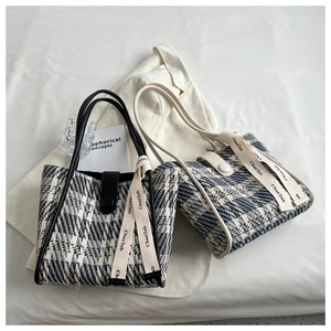 Flat lay of plaid tweed tote bags with magnetic closure and decorative ribbon detail