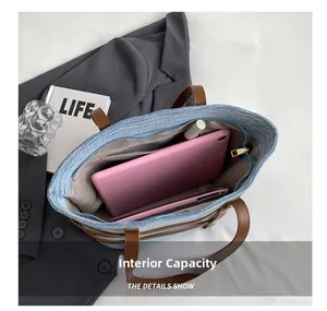 Interior capacity of denim tote bag showing space for tablet and lipstick inside