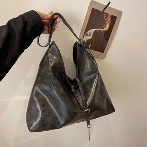 Detail of vintage textured large hobo bag with adjustable strap and rustic finish
