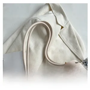 Close-up of tweed weave canvas tote bag with premium leather handles and elegant texture