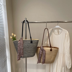 Large striped straw tote bag with paisley scarf and tassel fringe for summer beach vacations