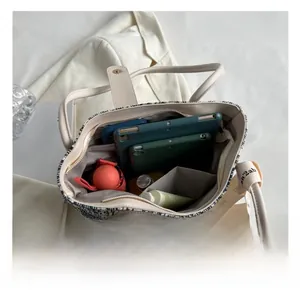 Detail view of the large capacity tote bag showing internal pockets and storage space