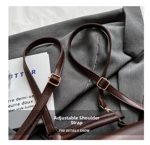 Detail of dark brown leather strap with adjustable gold metal buckle for vintage backpack