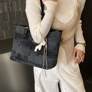 Fashionable commuter tote bag in dark grey textured fabric with black leather handles