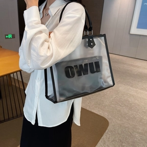 Side view of large transparent PVC tote bag with black inner pouch and long shoulder handles