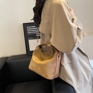 Detailed macro view of light brown PU leather texture and metal handle on crossbody bag