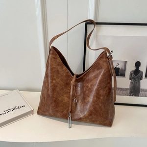 Retro brown faux leather tote bag with wide shoulder strap and metal ring detail