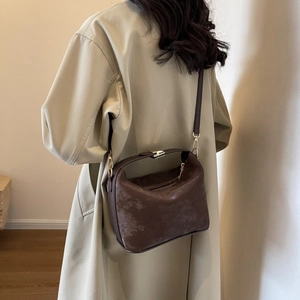 Detailed view of deep brown vintage textured PU leather square bag on a model