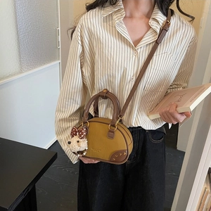 Retro mustard yellow and brown oval crossbody bag with a cute plush puppy pendant