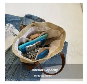 Interior view showing large capacity and multi-pocket design of the canvas tote bag