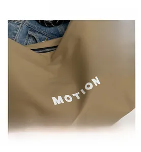 Detailed macro view of khaki nylon fabric texture with white MOTION lettering