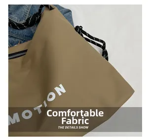Detail showing khaki nylon fabric texture with MOTION text and braided strap